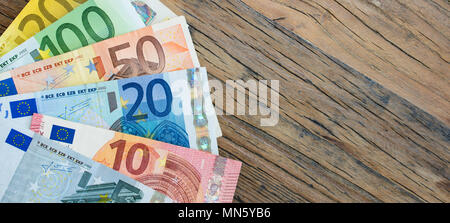 European banknotes on wood. Business, economic and financial concept. Stock Photo