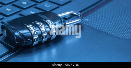 Network Security: Lock on computer keyboard. Blue tone. Stock Photo