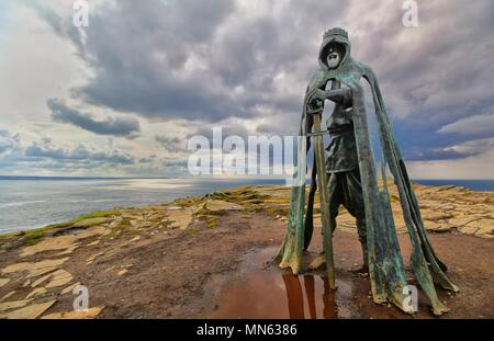 Tintagel, Cornwall, UK - April 10 2018: The King Arthur statue Gallos by Rubin Eynon stands on a rocky headland on the Atlantic coast of Cornwall. Stock Photo