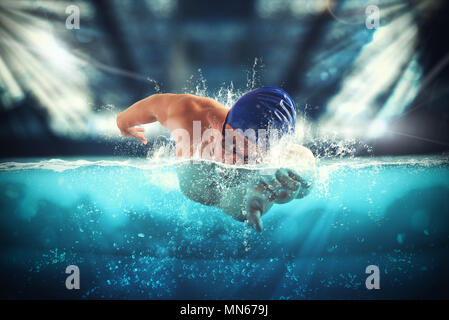 Athlete swims in a blue deep pool Stock Photo