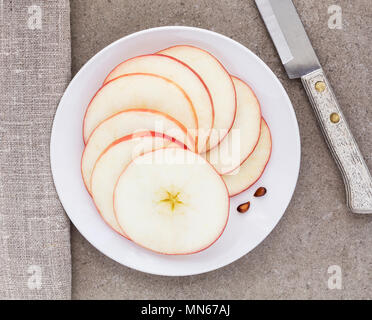 sliced apple presented on a white plate Stock Photo