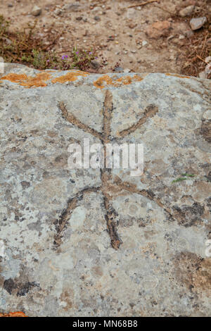 Ancient sign on stone at excavations in Phaistos in Crete. Meaning unknown so far to archaeologists at the site Stock Photo