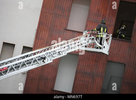 two firefighters in action with aerial platform during a practice at fire barracks Stock Photo