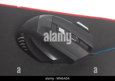Computer modern gaming mouse on black mouse pad isolated on a white background Stock Photo