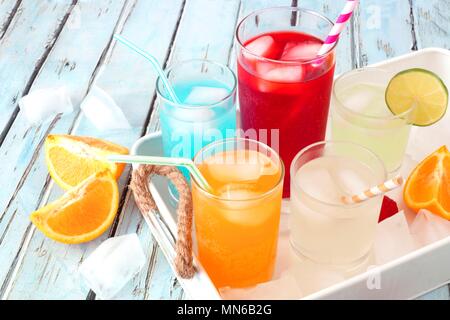 Tray of cool colorful summer drinks against a rustic wood background Stock Photo