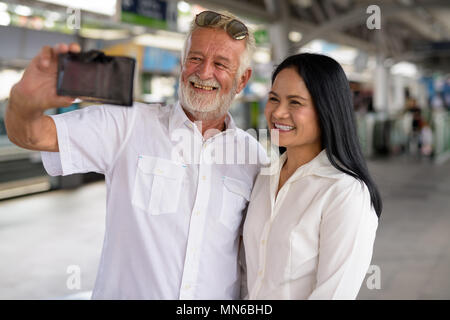Mature multi-ethnic couple happy and in love while exploring the Stock Photo