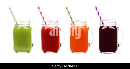 Four mason jar glasses of vegetable juice, greens, tomato, carrot and beet, isolated on a white background Stock Photo