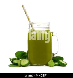 Mason jar glass of green vegetable juice with straw and surrounding ingredients isolated on a white background Stock Photo