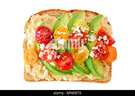 Avocado toast with hummus and tomatoes isolated on a white background Stock Photo