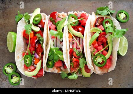 Spicy fish tacos with watermelon salsa and avocados, above view on rustic metallic background Stock Photo