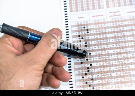 Man hand Erasing answer with pencil on Test score sheet with answers. Stock Photo