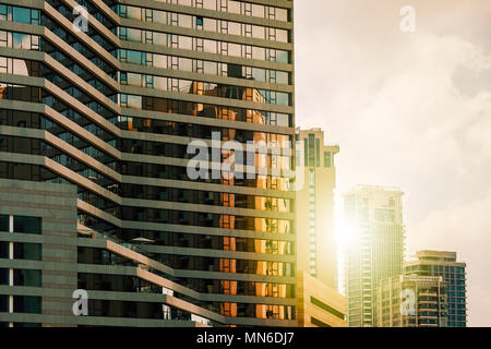 View of modern hotel lined with glass as contemporary residential high-rise buildings on background in Tel Aviv, Israel. Stock Photo