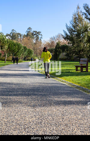 Vila Nova de Famalicao, Portugal. Mature woman running or jogging in Parque da Devesa Urban Park. Built near the center of the city. Stock Photo