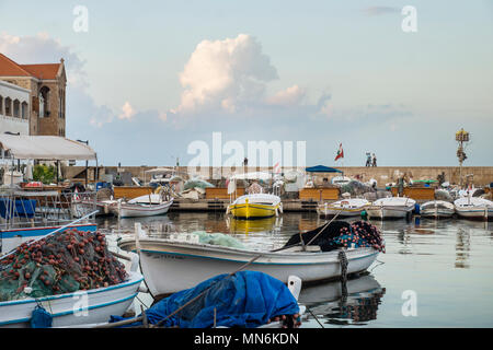 People and army on the wall of the fishing harbour of Tyre, Lebanon Stock Photo