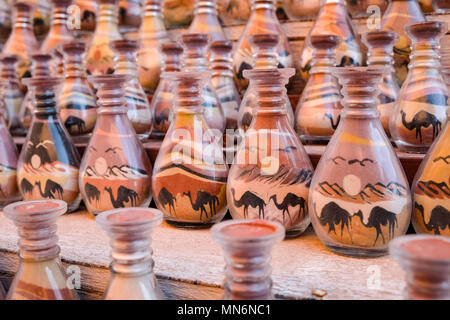 Bottles in a row with sand art for sale in the ancient Nabatean city Stock Photo