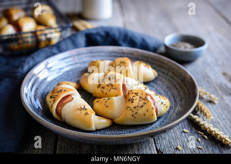 Homemade baked rolls stuffed with bacon slices and cheese Stock Photo