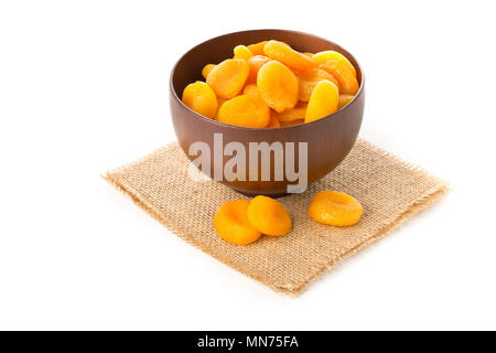 Whole dried apricots fruit in wooden bowl over white background Stock Photo