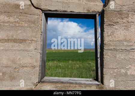 Prairie view through window of abandoned house Stock Photo