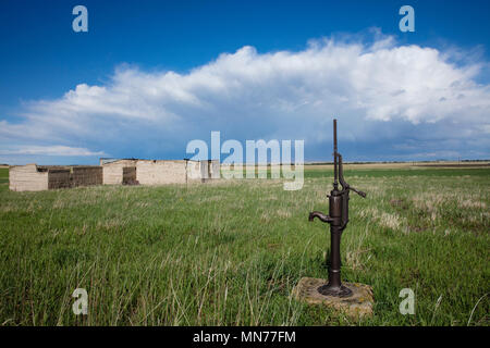 Abandoned prairie house with hand pump well. Stock Photo
