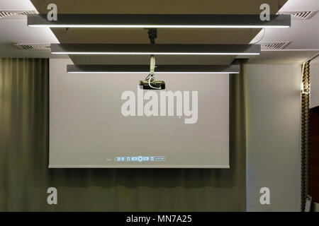 Projector in a room with projector screen on back ground Stock Photo