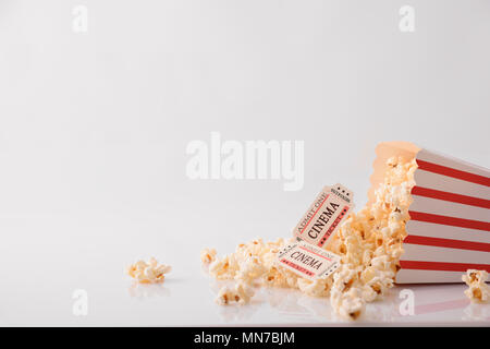 Cinema moments concept with popcorn and movie tickets on white background. Horizontal composition. Front view. Stock Photo