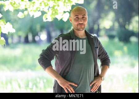 face of a bearded serious bald man in the park. Portrait of a middle-aged man.