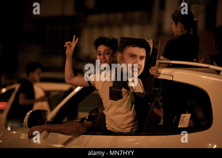 A young boy holds up a picture of Iraqi Shiite cleric Muqtada al-Sadr, as al-Sadr supporters gather to celebrate in the streets of Baghdad, Iraq, early on 15 May 2018. Influential Shiite cleric Moqtada al-Sadr's electoral list leads in Iraq's parliamentary elections with more than half of the counted votes, as the electoral commission announced results in 16 out of the country's 18 provinces. Photo: Ameer Al Mohammedaw/dpa Stock Photo