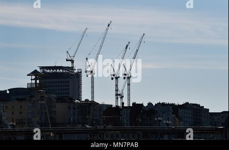 Brighton UK 15th May 2018 - Cranes at the Royal Sussex County Hospital in Brighton are silhouetted against the sky on a beautiful sunny morning in Brighton seafront with the temperature forecast to reach into the 20s again today Credit: Simon Dack/Alamy Live News Stock Photo