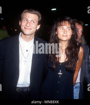 HOLLYWOOD, CA - AUGUST 16: (L-R) Actor Christian Slater and girlfriend Nina Huang attend the premiere of 'Pump Up The Volume' at Mann's Chinese Theatre on August 16, 1990 in Hollywood, California. Photo by Barry King/Alamy Stock Photo Stock Photo