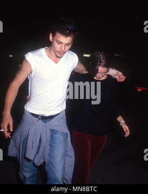 LOS ANGELES, CA - AUGUST 18: (L-R) Actor Johnny Depp and actress Winona Ryder attend Herb Ritt's Birthday Party on August 18, 1990 in Los Angeles, California. Photo by Barry King/Alamy Stock Photo Stock Photo