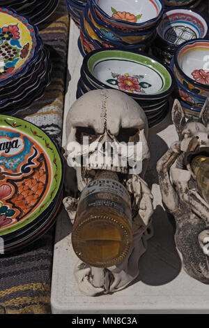 beer drinking skull between colored ceramic bowls at a stall in mahahual, quintana roo, mexico Stock Photo