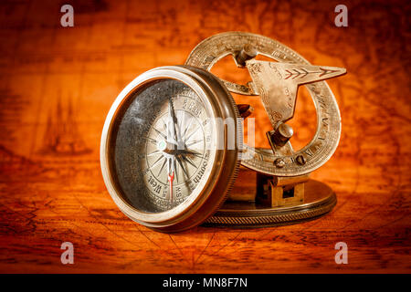 Vintage still life. Vintage compass lies on an ancient world map in 1565. Stock Photo