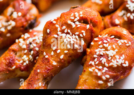 Roasted chicken wings covered with sesame closeup Stock Photo