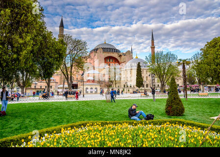 Traditional tulip Festival in Sultanahmet Square Park with view of Hagia Sophia,a Greek Orthodox Christian patriarchal basilica (church) on background Stock Photo