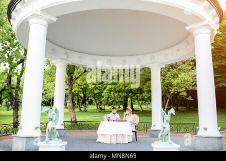 View on the beautiful royal alcove with couple having romantic breakfast in the garden Stock Photo
