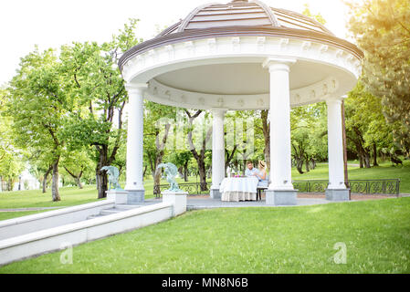 View on the beautiful royal alcove with couple having romantic breakfast in the garden Stock Photo