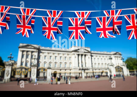 Union Jack flag bunting decorates the Mall in front of Buckingham Palace ahead of the Royal Wedding in London, England. Stock Photo