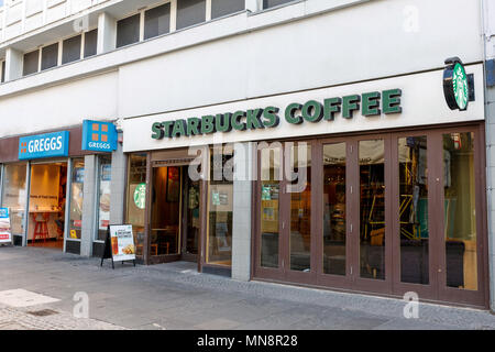 Neighbouring branches of Greggs and Starbucks Coffee on a British high street. Stock Photo