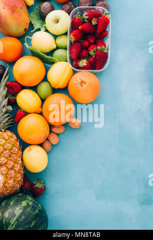 Organic  green fruit and veggie wallpaper over a blue board, top view,flat lay, copyspace left. Stock Photo