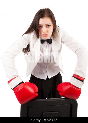 Young angry businesswoman in boxing gloves Stock Photo