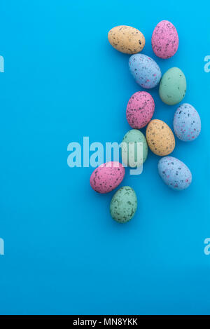 Mini speckled easter eggs from above on colourful backgrounds, with copyspace. Stock Photo