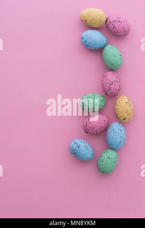 Mini speckled easter eggs from above on colourful backgrounds, with copyspace. Stock Photo