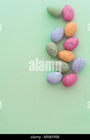 Mini speckled easter eggs from above on colourful backgrounds, with copyspace. Stock Photo