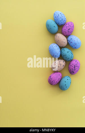 Mini speckled easter eggs from above on colourful backgrounds, with copyspace. Stock Photo