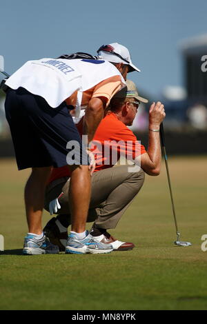 MUIRFIELD, SCOTLAND - JULY 19: Miguel Angel Jimenez studying the putt with his caddie at the 9th green during the second round of The Open Championship 2013 at Muirfield Golf Club on July 19, 2013 in Scotland. Stock Photo