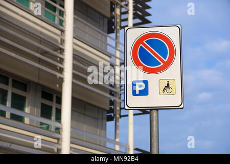 handicapped sign mark parking spot, disabled parking permit sign on pole with convenience store in gas station area background, copy space Stock Photo