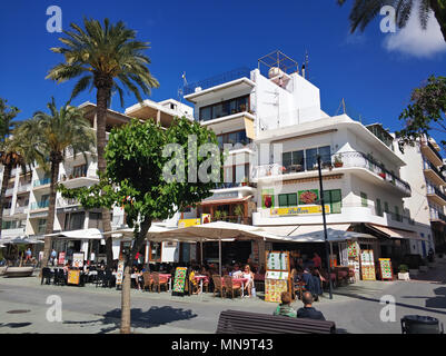 Ibiza Island, Spain - May 02, 2018: People sitting at the outdoors restaurant in the Sant Antoni town. San Antonio is one of the most popular and well Stock Photo