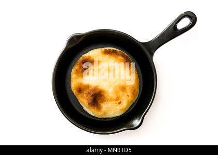 Arepas in frying pan isolated on white background. Venezuelan typical food. Top view Stock Photo