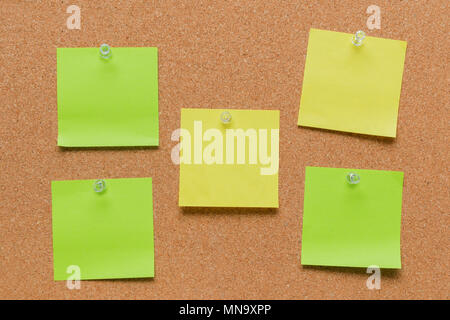 empty square green and yellow pinned sheet on a brown cork reminder Stock Photo