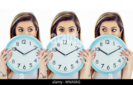 Girls looking over clock face at each other Stock Photo